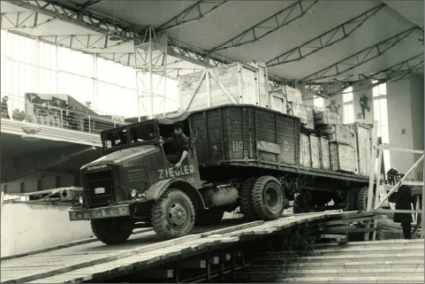 A Ziegler transport vehicle going down a wooden ramp in a warehouse