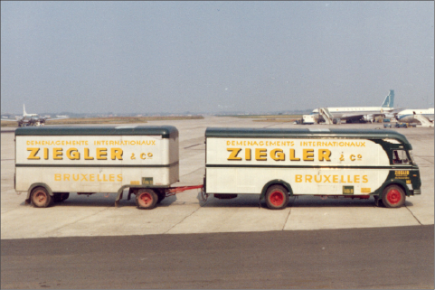 A Ziegler branded transport vehicle driving on the airport tarmac delivering goods.